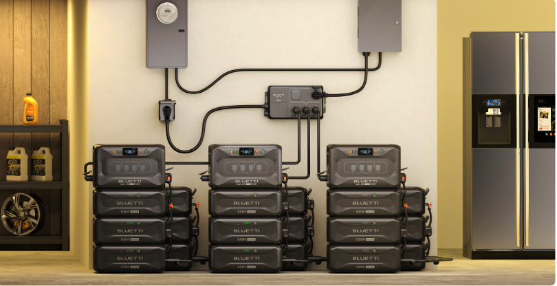 Stack of black battery packs in a room with a refrigerator and shelves.